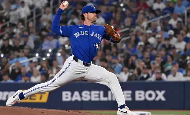 Toronto Blue Jays starting pitcher Shane Bieber (57) throws to a Chicago White Sox batter during first inning of a baseball game in Toronto, Saturday, July 18, 2026. (Jon Blacker/The Canadian Press via AP)