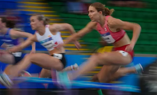 Canada's Hannah Blair, right, and Jersey's Lucy Woodward compete in the Women's Heptathlon 100m hurdles at the Commonwealth Games in Glasgow, Scotland, Tuesday, July 28, 2026. (AP Photo/Alastair Grant)