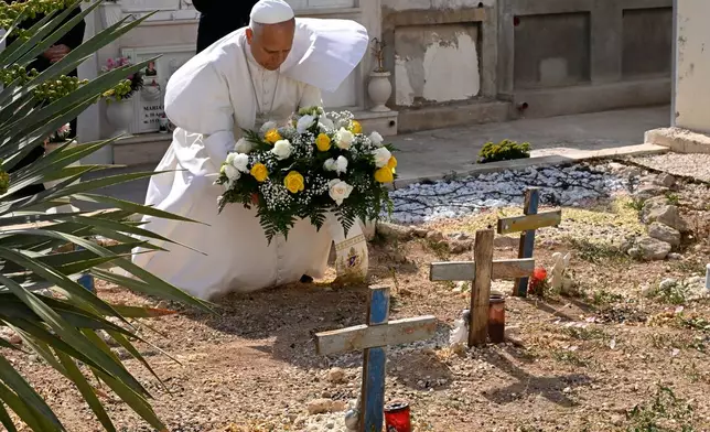 Pope Leo XIV pays tribute at the cemetery and on little Joussef's grave, in Lampedusa, Sicily, southern Italy, Saturday, July 4, 2026, during a one-day pastoral visit to an island that has become a symbol of the risks faced by migrants trying to reach Europe by sea.(Pool Photo/Ciro Fusco, Via AP)