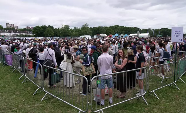 Tennis fans queue in the early morning to buy tickets for the Wimbledon Tennis Championships in London, Saturday, July 4, 2026.(AP Photo/Brian Inganga)