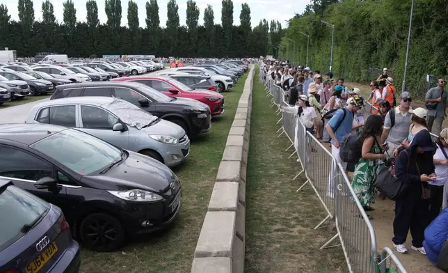 Tennis fans queue in the early morning to buy tickets for the Wimbledon Tennis Championships in London, Saturday, July 4, 2026.(AP Photo/Brian Inganga)