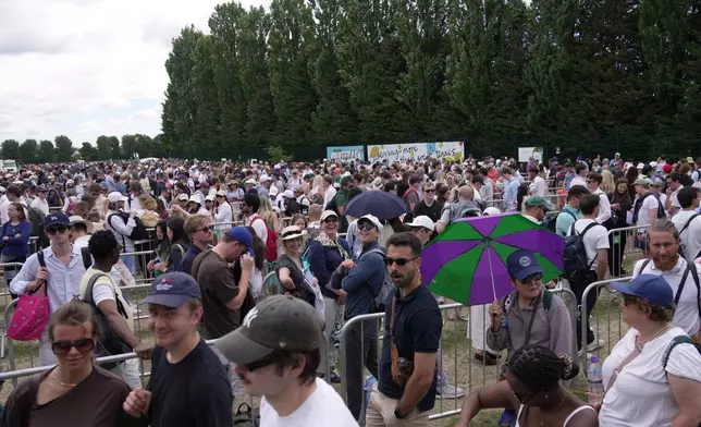Tennis fans queue in the early morning to buy tickets for the Wimbledon Tennis Championships in London, Saturday, July 4, 2026.(AP Photo/Brian Inganga)
