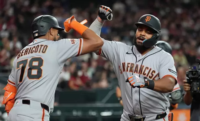 San Francisco Giants' Heliot Ramos, right, celebrates his home run against the Arizona Diamondbacks with Giants' Victor Bericoto (78) during the fifth inning of a baseball game, Wednesday, July 1, 2026, in Phoenix. (AP Photo/Ross D. Franklin)