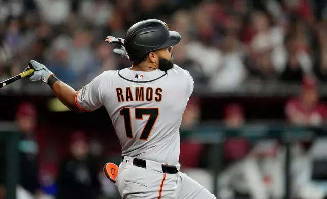 San Francisco Giants' Heliot Ramos watches the flight of his home run against the Arizona Diamondbacks during the fifth inning of a baseball game, Wednesday, July 1, 2026, in Phoenix. (AP Photo/Ross D. Franklin)