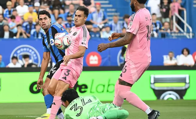 Inter Miami CF's Sergio Reguilon (3) and Micael Dos Santos Silva (16) defend as goalkeeper Rocco Rios Novo (34) comes out for the ball as CF Montreal's Daniel Rios, left, attempts a shot on goal during first half MLS soccer action in Montreal, on Saturday, July 25, 2026. (Graham Hughes/The Canadian Press via AP)