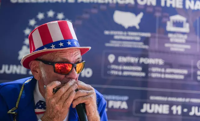 Duane Schwingel plays a harmonica on the National Mall, Friday, July 3, 2026, in Washington. (AP Photo/Julia Demaree Nikhinson)