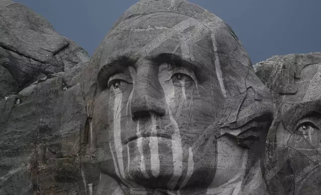Rain runs down a sculpture of George Washington at Mount Rushmore National Memorial, Friday, July 3, 2026, in Keystone, S.D. (AP Photo/Matt Gade)