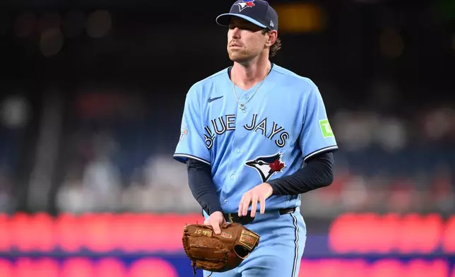 Toronto Blue Jays pitcher Shane Bieber walks back to the dugout after he was pulled from a baseball game in the first inning against the Washington Nationals, Tuesday, July 28, 2026, in Washington. (AP Photo/Nick Wass)