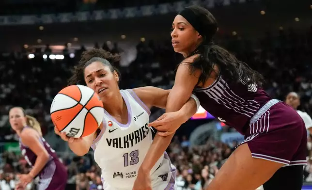 Golden State Valkyries forward Janelle Salaun (13) grabs a loose ball in front of Toronto Tempo forward Isabelle Harrison during the second half of a WNBA basketball game in Toronto on Wednesday, July 8, 2026. (Chris Young/The Canadian Press via AP)