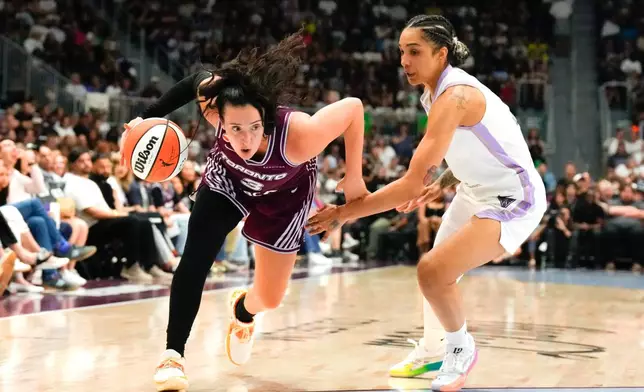 Toronto Tempo Marina Mabrey (3) drives past Golden State Valkyries Gabby Williams (1) during the first half of a WNBA basketball game in Toronto on Wednesday, July 8, 2026. (Chris Young/The Canadian Press via AP)