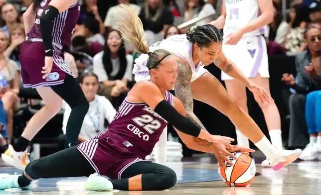 Toronto Tempo Julie Allemand (22) battles for a loose ball with Golden State Valkyries Gabby Williams during the first half of a WNBA basketball game in Toronto on Wednesday, July 8, 2026. (Chris Young/The Canadian Press via AP)