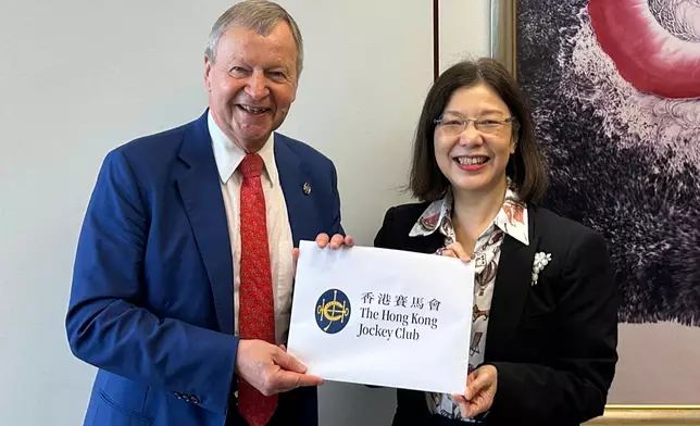 Winfried Engelbrecht-Bresges, Chief Executive Officer of The Hong Kong Jockey Club (left) submits a proposal for Hong Kong’s first Five-Year Plan to Janice Tse, Secretary for Constitutional and Mainland Affairs of the HKSAR Government (right).