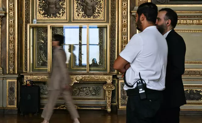 Visitors arrive during the reopening to the public of the Apollo Gallery, at the Louvre museum in Paris, Wednesday, July 22, 2026. (Lou Benoist/Pool Photo via AP)