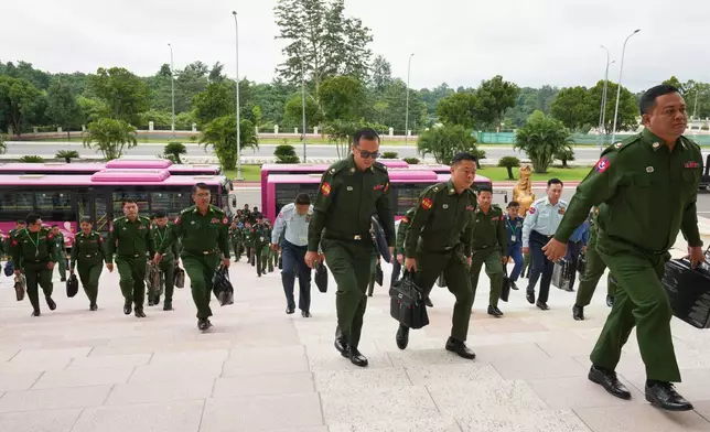 Myanmar's military representatives arrive to attend a regular session of the Union Parliament in Naypyitaw, Myanmar, Friday, July 31, 2026. (AP Photo/Aung Shine Oo)
