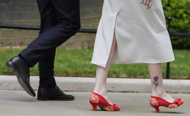 The shoes of Angela Rayner, Britain's Secretary of State for Housing, Communities and Local Government, right, as she leaves after attending a Cabinet meeting in Downing Street in London, Tuesday, July 21, 2026. (AP Photo/Kirsty Wigglesworth)