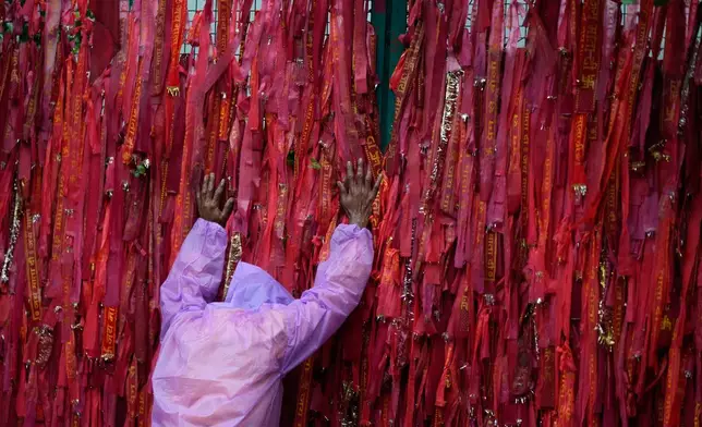 A stranded Hindu devotee prostrates at the starting point of the pilgrimage to the holy Vaishno Devi Temple in Katra, India, Tuesday, July 21, 2026, as the Mata Vaishno Devi Yatra remains suspended for a third day amid persistent heavy rainfall and adverse weather conditions. (AP Photo/Channi Anand)