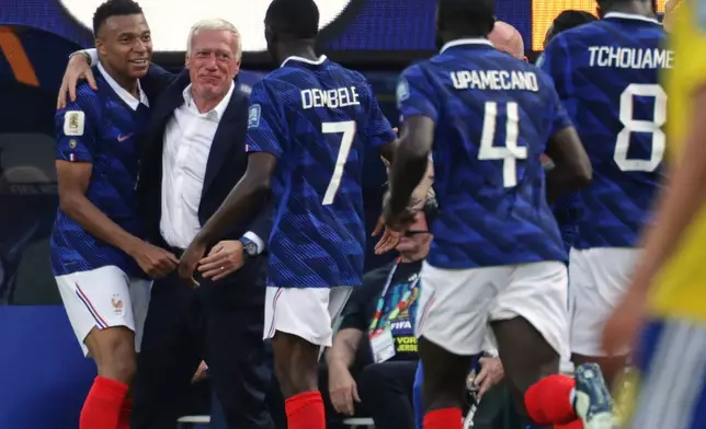 France's Kylian Mbappe, left, celebrates their first goal with head coach Didier Deschamps, second from left, and teammates during the World Cup round of 32 soccer match between France and Sweden in East Rutherford, N.J., near New York, Tuesday, June 30, 2026. (AP Photo/Adam Hunger)