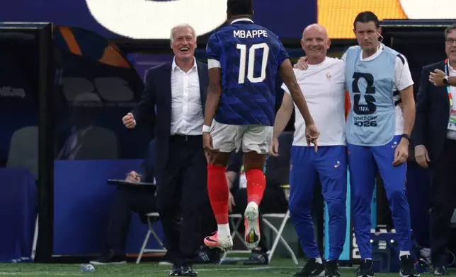 France head coach Didier Deschamps, left, celebrates their first goal with Kylian Mbappe (10) during the World Cup round of 32 soccer match between France and Sweden in East Rutherford, N.J., near New York, Tuesday, June 30, 2026. (AP Photo/Adam Hunger)