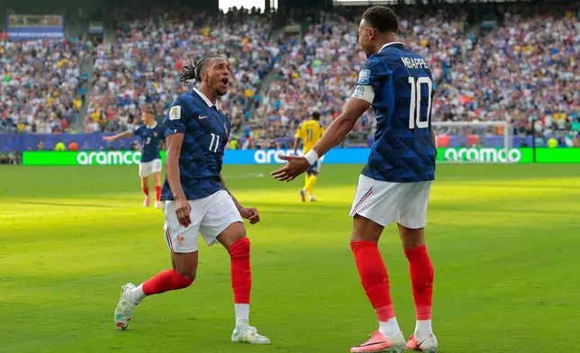 France's Kylian Mbappe (10) celebrates scoring their third goal with Michael Olise (11) during the World Cup round of 32 soccer match between France and Sweden in East Rutherford, N.J., near New York, Tuesday, June 30, 2026. (AP Photo/Pamela Smith)