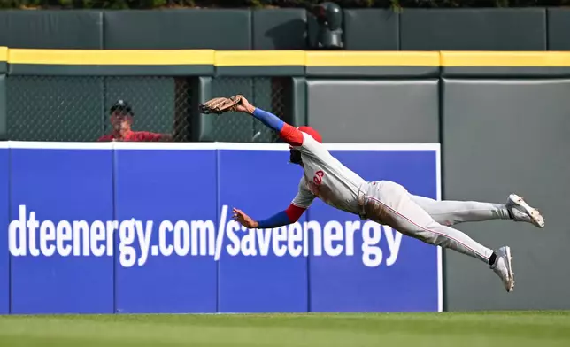 Philadelphia Phillies center fielder Derek Hill makes a leaping catch to take away a hit from the Detroit Tigers in the third inning of a baseball game, Saturday, July 11, 2026, in Detroit. (AP Photo/Lon Horwedel)