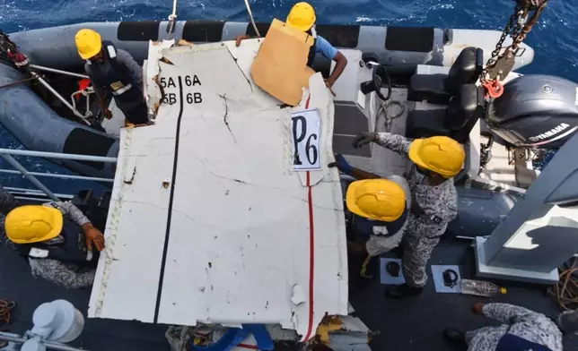 In this photo released by Pakistan Navy, Pakistan Navy personnel shift the wreckage of a cargo plane of the private carrier K2 Airways into a naval ship after recovering them from deep sea near Omara, a town some 360 kms. (220 miles) west of Karachi, Pakistan, Wednesday, July 8, 2026. (Pakistan Navy via AP)