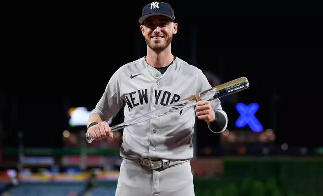 New York Yankees' Cody Bellinger poses with the MVP trophy after the MLB baseball All-Star Game between the American League and National League, Tuesday, July 14, 2026, in Philadelphia. (AP Photo/Matt Slocum)