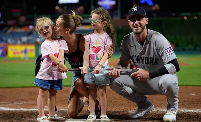 New York Yankees' Cody Bellinger, right, Chase Carter Bellinger and their kids pose with the MVP trophy after the MLB baseball All-Star Game between the American League and National League, Tuesday, July 14, 2026, in Philadelphia. (AP Photo/Matt Slocum)