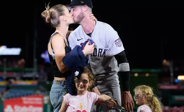 New York Yankees' Cody Bellinger kisses Chase Carter Bellinger after he won the MVP trophy after the MLB baseball All-Star Game between the American League and National League, Tuesday, July 14, 2026, in Philadelphia. (AP Photo/Matt Slocum)