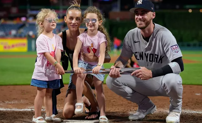 New York Yankees' Cody Bellinger, right, Chase Carter Bellinger and their kids pose with the MVP trophy after the MLB baseball All-Star Game between the American League and National League, Tuesday, July 14, 2026, in Philadelphia. (AP Photo/Matt Slocum)