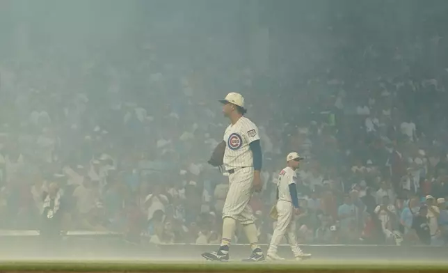 Chicago Cubs pitcher Shota Imanaga stands amidst smoke after fireworks before a baseball game against the St. Louis Cardinals, Saturday, July 4, 2026, in Chicago. (AP Photo/David Banks)
