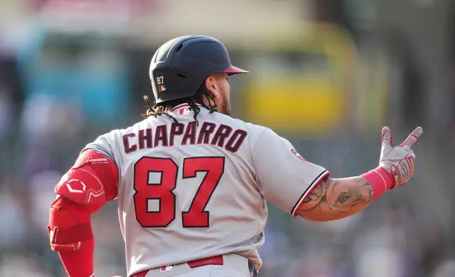 Washington Nationals' Andrés Chaparro gestures to the bullpen as he circles the bases after hitting a three-run home run off Colorado Rockies starting pitcher Kyle Freeland in the first inning of a baseball game Monday, July 20, 2026, in Denver. (AP Photo/David Zalubowski)