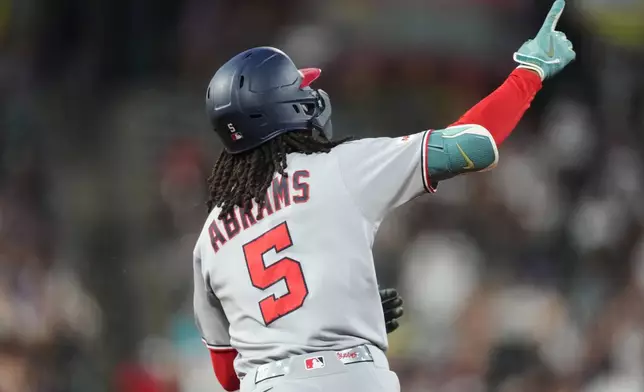 Washington Nationals' CJ Abrams gestures to the bullpen as he circles the bases after hitting a two-run home run off Colorado Rockies relief pitcher Antonio Senzatela in the seventh inning of a baseball game Monday, July 20, 2026, in Denver. (AP Photo/David Zalubowski)