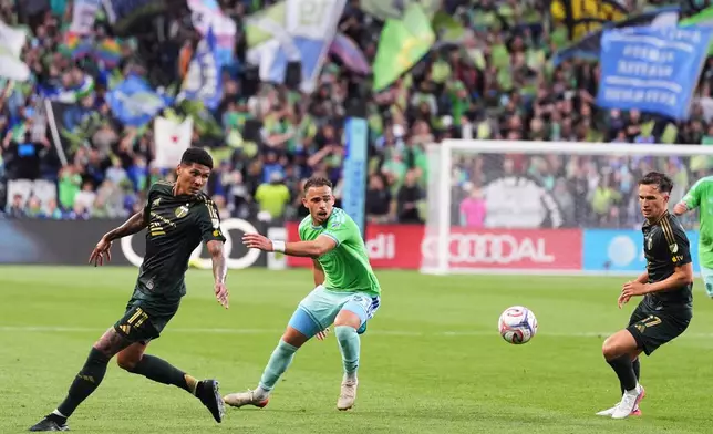 Seattle Sounders defender Hassani Dotson, center, loses the ball against Portland Timbers forward Antony, left, and midfielder Cole Bassett, right, during the first half of an MLS soccer match, Thursday, July 16, 2026, in Seattle. (AP Photo/Lindsey Wasson)