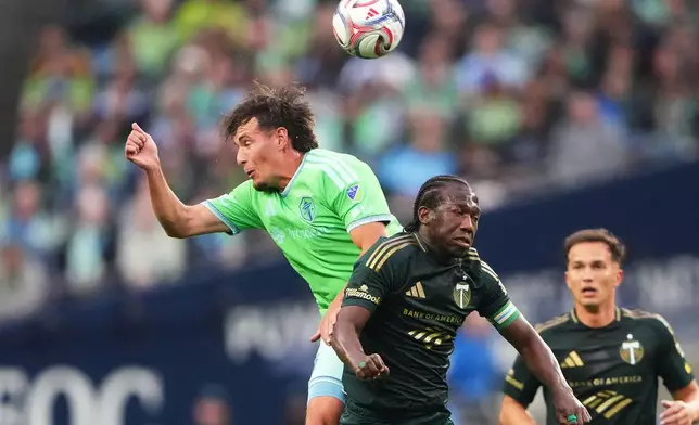 Seattle Sounders midfielder Snyder Brunell goes up for the ball against Portland Timbers midfielder Diego Chará, right, during the first half of an MLS soccer match, Thursday, July 16, 2026, in Seattle. (AP Photo/Lindsey Wasson)