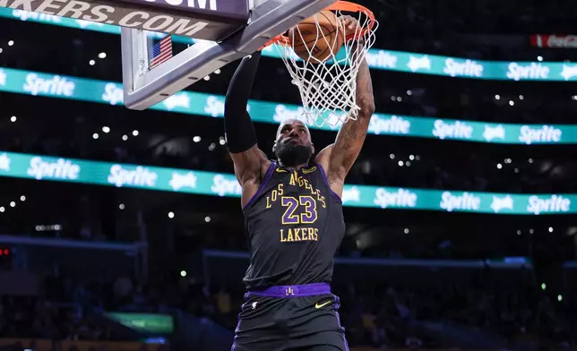FILE - Los Angeles Lakers forward LeBron James (23) dunks against the Phoenix Suns during the second half of an NBA basketball game, April 10, 2026, in Los Angeles. (AP Photo/Jessie Alcheh, File)