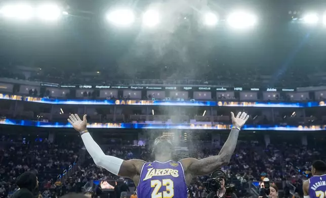 FILE - Los Angeles Lakers forward LeBron James throws chalk in the air before an NBA basketball game against the Golden State Warriors in San Francisco, April 9, 2026. (AP Photo/Jeff Chiu, File)