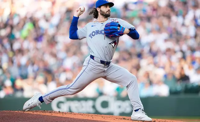 Toronto Blue Jays starting pitcher Dylan Cease throws against the Seattle Mariners during the first inning of a baseball game, Friday, July 3, 2026, in Seattle. (AP Photo/Lindsey Wasson)