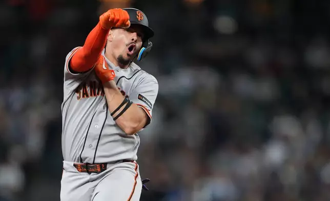 San Francisco Giants' Willy Adames celebrates while jogging the bases after hitting a grand slam against the Seattle Mariners during the seventh inning of a baseball game, Friday, July 17, 2026, in Seattle. (AP Photo/Lindsey Wasson)