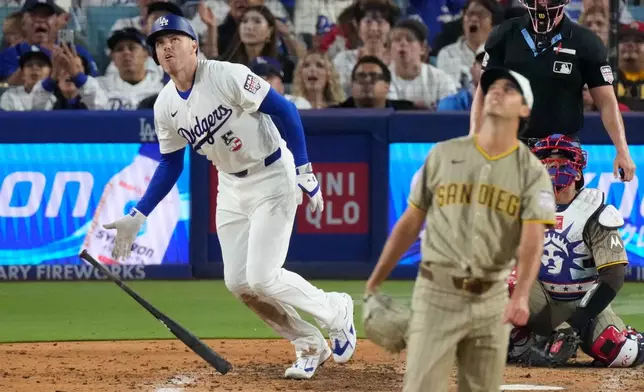 Los Angeles Dodgers' Freddie Freeman, left, heads to first for a solo home run as San Diego Padres pitcher Kyle Hart, second from left, and catcher Luis Campusano watch during the sixth inning of a baseball game Saturday, July 4, 2026, in Los Angeles. (AP Photo/Mark J. Terrill)