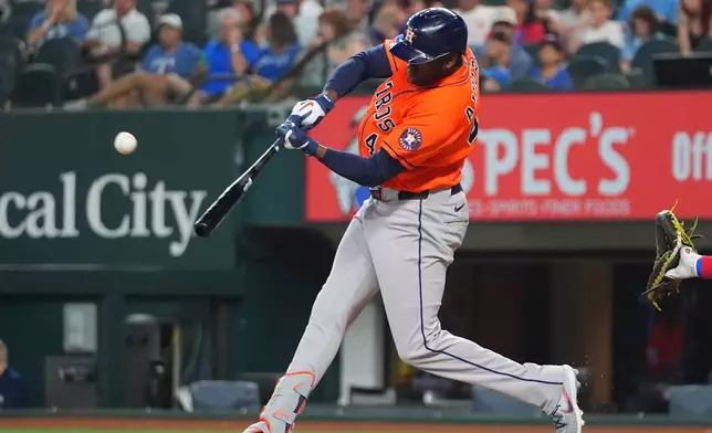 Houston Astros designated hitter Yordan Alvarez hits a home run against the Texas Rangers during the first inning of a baseball game, Saturday, July 11, 2026, in Arlington, Texas. (AP Photo/LM Otero)