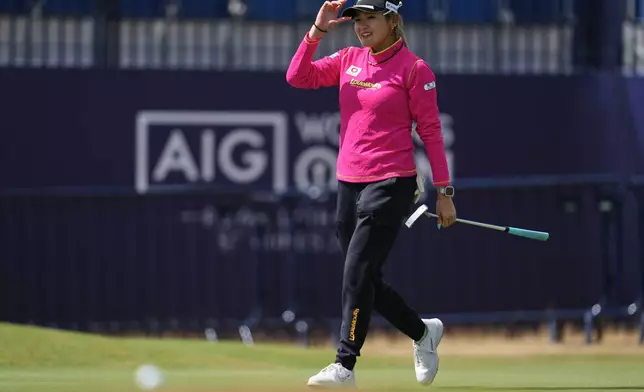 Shiho Kuwaki, of Japan, acknowledges the crowd after putting on the 18th green during the second round of the Women's British Open golf championship in Lytham St Annes, England, Friday, July 31, 2026. (AP Photo/Jon Super)