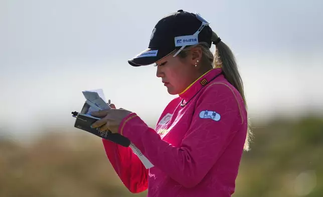 Shiho Kuwaki, of Japan, takes note as she walks off the 3rd green during the second round of the Women's British Open golf championship in Lytham St Annes, England, Friday, July 31, 2026. (AP Photo/Jon Super)