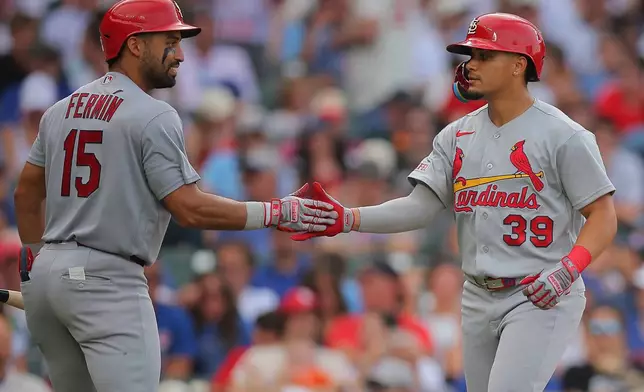 St. Louis Cardinals' Bryan Torres (39 celebrates after hitting a home run with José Fermín (15) during the seventh inning of a baseball game against the Chicago Cubs, Friday, July 3, 2026, in Chicago. (AP Photo/Melissa Tamez)