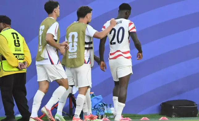 United States' Sebastian Berhalter (14) consoles Folarin Balogun (20) after he received a red card during the World Cup round of 32 soccer match between the United States and Bosnia in Santa Clara, Calif., near San Francisco, Wednesday, July 1, 2026. (AP Photo/Eakin Howard)
