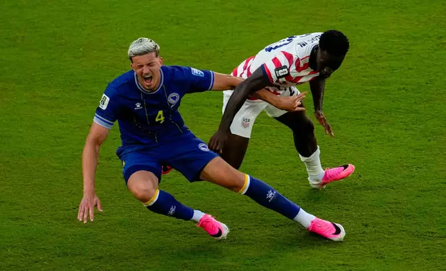 United States' Folarin Balogun (20) fouls Bosnia's Tarik Muharemovic (4) during the World Cup round of 32 soccer match between the United States and Bosnia in Santa Clara, Calif., near San Francisco, Wednesday, July 1, 2026. Balogun received a red card on the play. (AP Photo/Jeff Chiu)