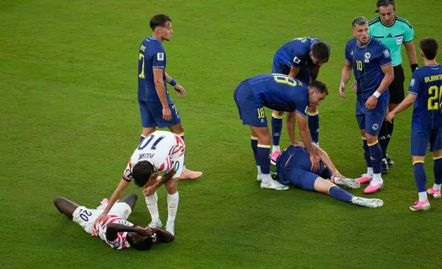 United States' Folarin Balogun (20) lays on the pitch after a foul against Bosnia's Tarik Muharemovic (4) during the World Cup round of 32 soccer match between the United States and Bosnia in Santa Clara, Calif., near San Francisco, Wednesday, July 1, 2026. Balogun received a red card on the play. (AP Photo/Jeff Chiu)