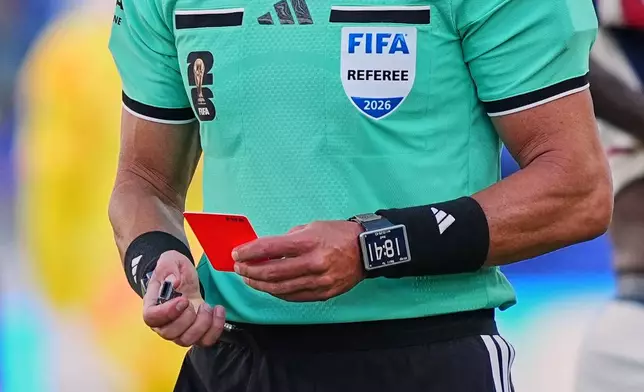 FILE - Referee Raphael Claus, of Brazil, holds the red card after sending United States' Folarin Balogun off the pitch during the World Cup round of 32 soccer match between the United States and Bosnia in Santa Clara, Calif., near San Francisco, Wednesday, July 1, 2026. (AP Photo/Martin Meissner, File)