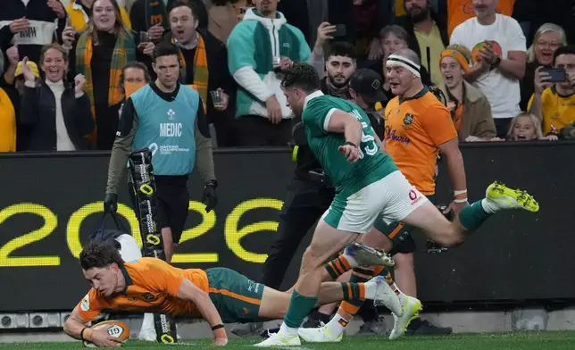 Australia's Jock Campbell, left scores his side second try during the Nations Championship rugby international between Australia and Ireland in Sydney, Saturday July, 4, 2026. (AP Photo/Mark Baker)