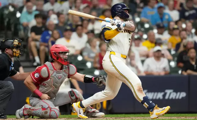 Milwaukee Brewers' Garrett Mitchell hits an RBI triple during the seventh inning of a baseball game against the Cincinnati Reds, Wednesday, July 1, 2026, in Milwaukee. (AP Photo/Aaron Gash)