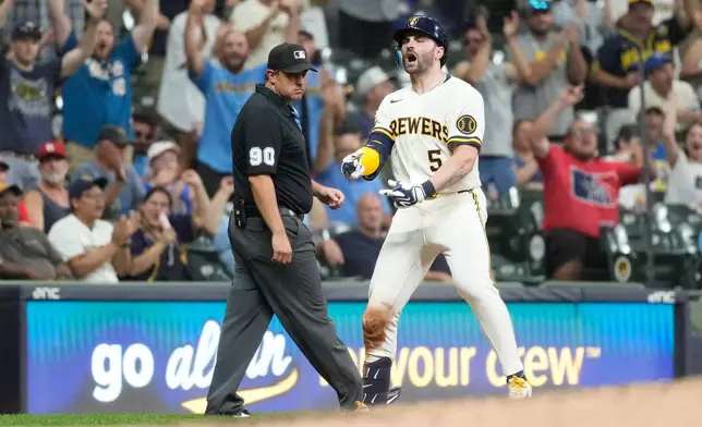 Milwaukee Brewers' Garrett Mitchell reacts after hitting an RBI triple during the seventh inning of a baseball game against the Cincinnati Reds, Wednesday, July 1, 2026, in Milwaukee. (AP Photo/Aaron Gash)